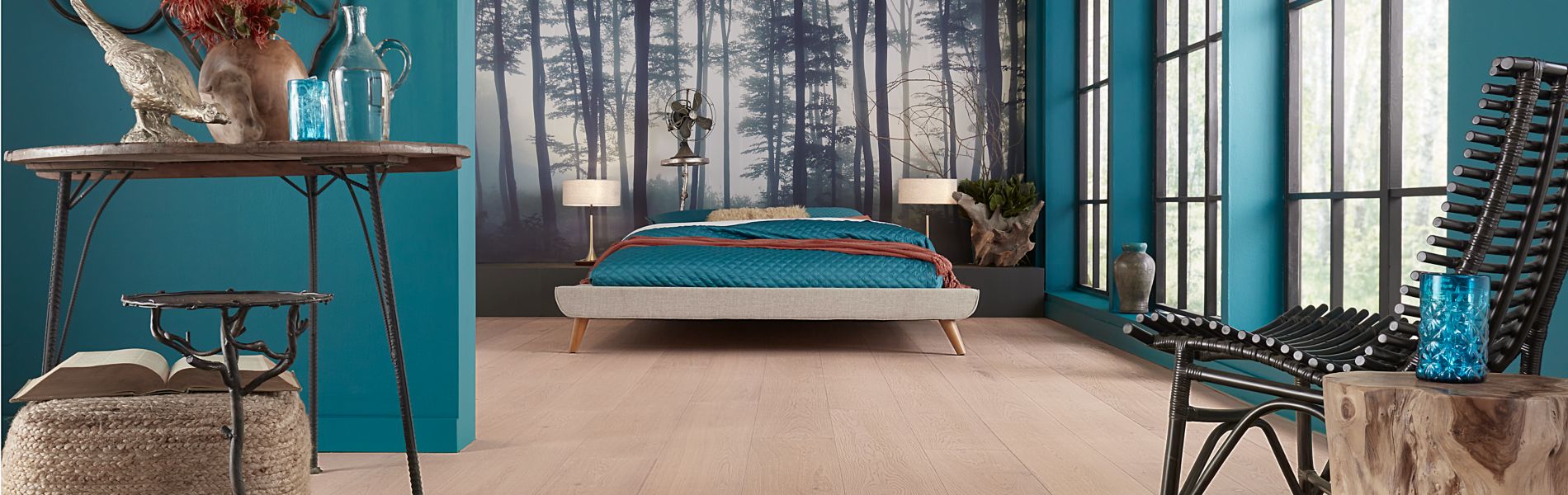 Light laminate floors in an aqua blue bedroom with natural finished