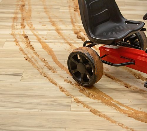 muddy toy tracks on light hardwood floors